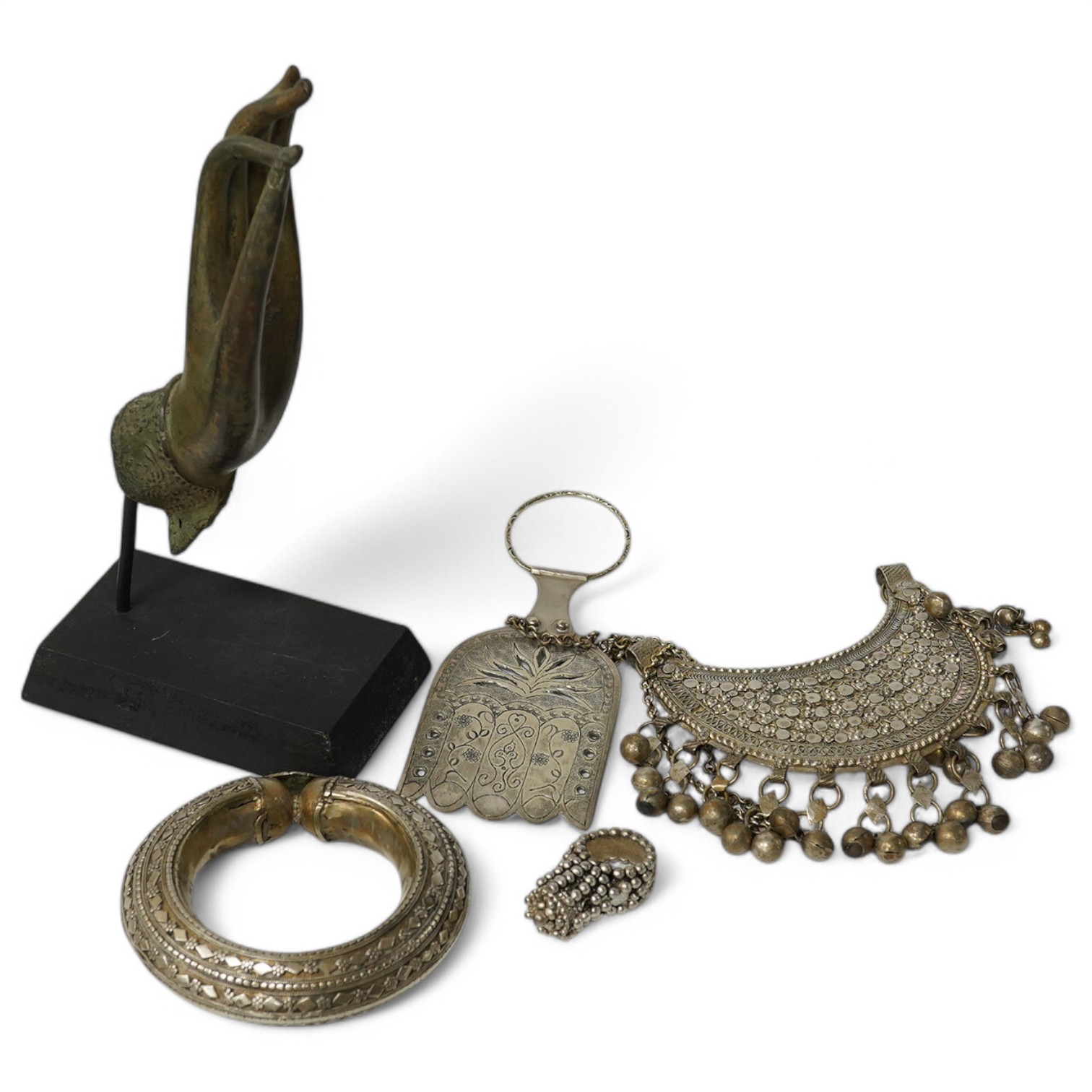 A group of Middle Eastern white metal items, a Hand of Fatima bracelet, ring, necklace and a Buddhist Mudra hand sculpture, tallest 24cm high. Condition - bangle a.f.